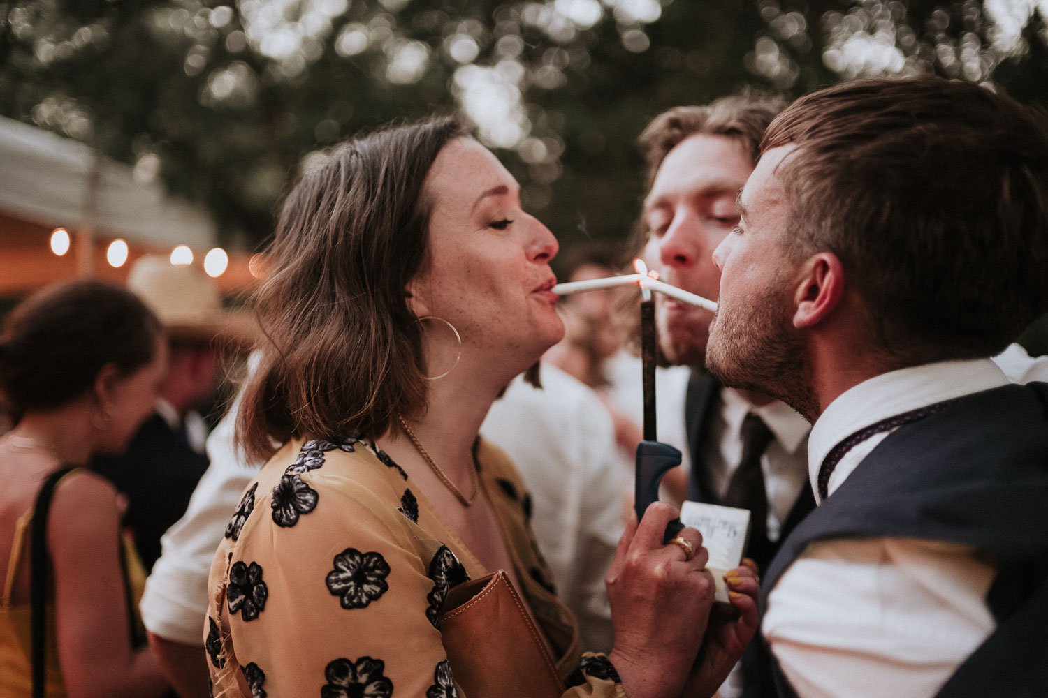 Guests light up cigarettes in celebration of the couple Texas Hill Country Ranch Wedding 