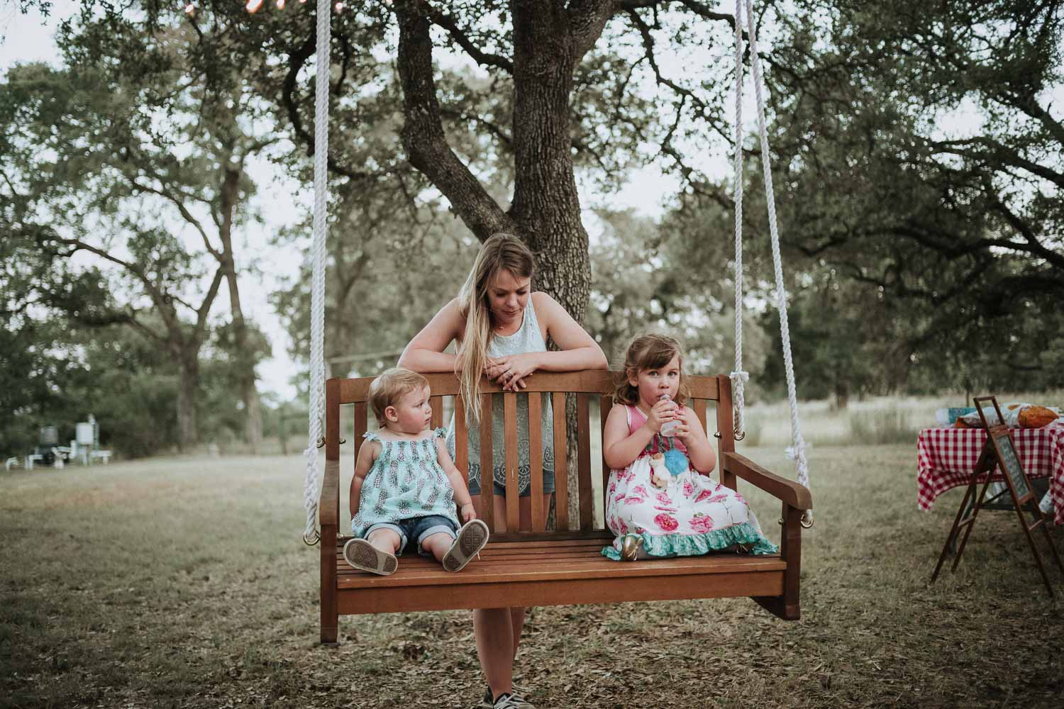 Kids pushed on a tress swing in Bulverde, Texas