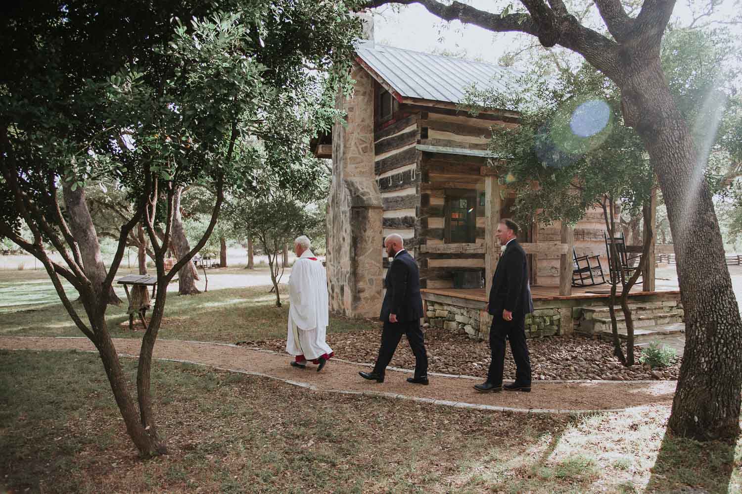 Groom and groomsmen walk toward ceremony site