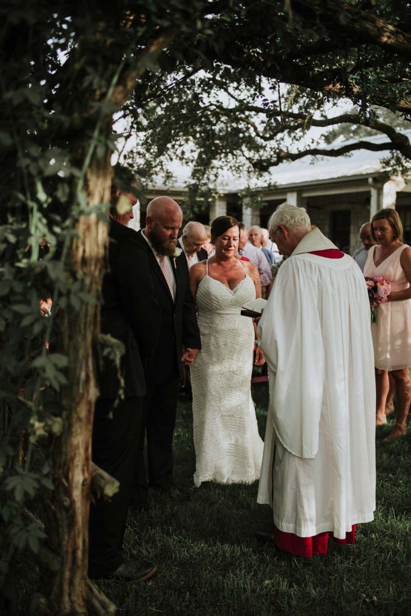 A view from behind the minister as the couple start to share vows