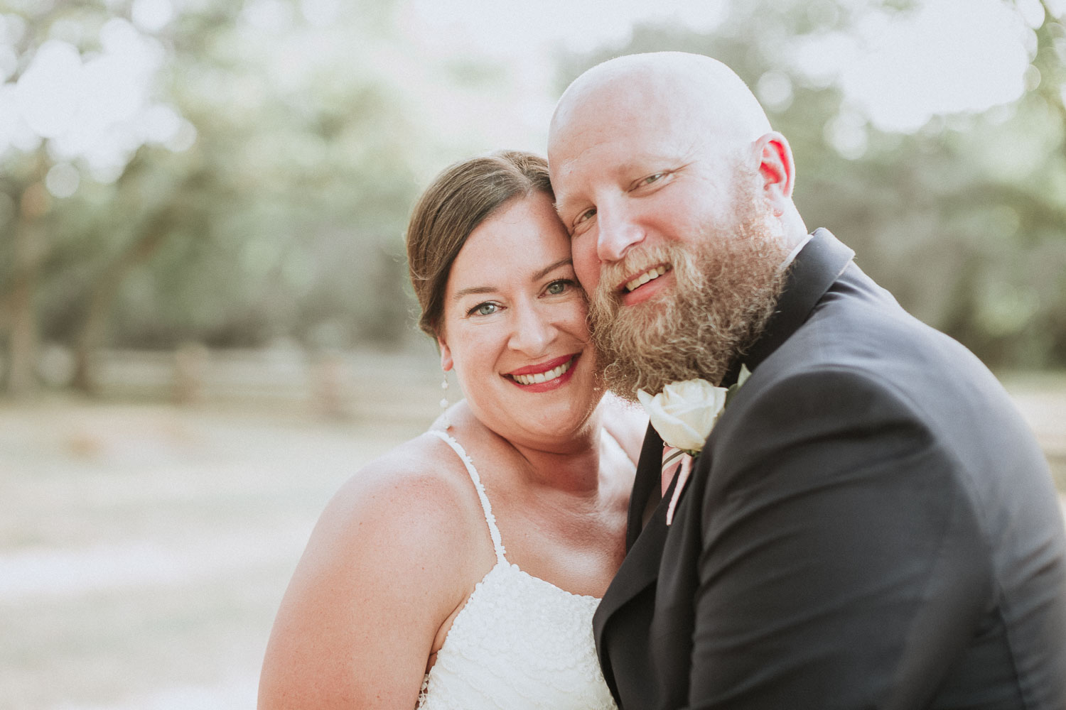 Dru and Kerry smile for the camera on their wedding day in Bulverde, Texas