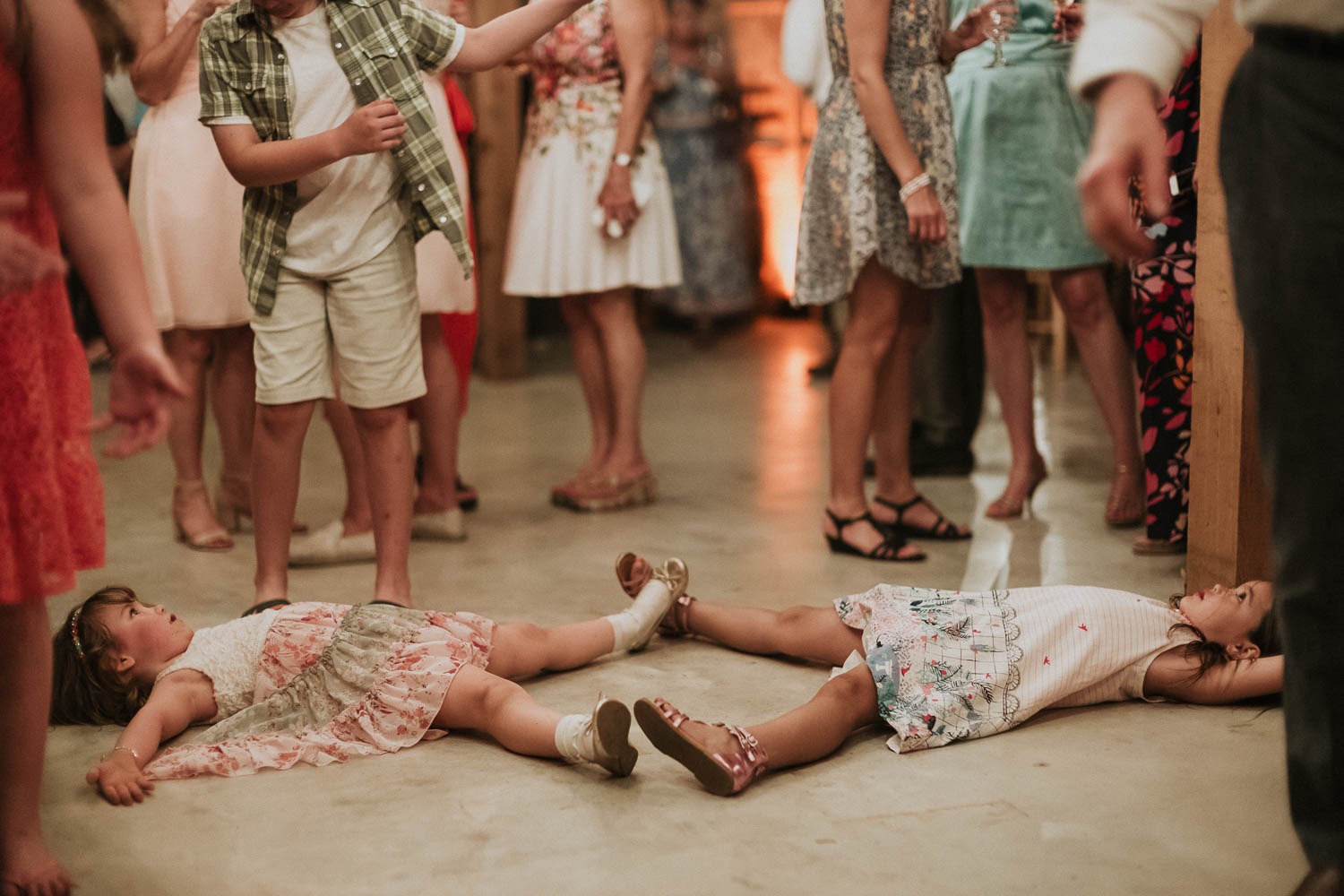 Kids are kids - lying on reception floor - Bulverde Wedding Photographer Philip Thomas - Dru+Kerry-47 Kids lying on reception floor Funny antics between two girls at a wedding reception shows the young girls lying down touch feet