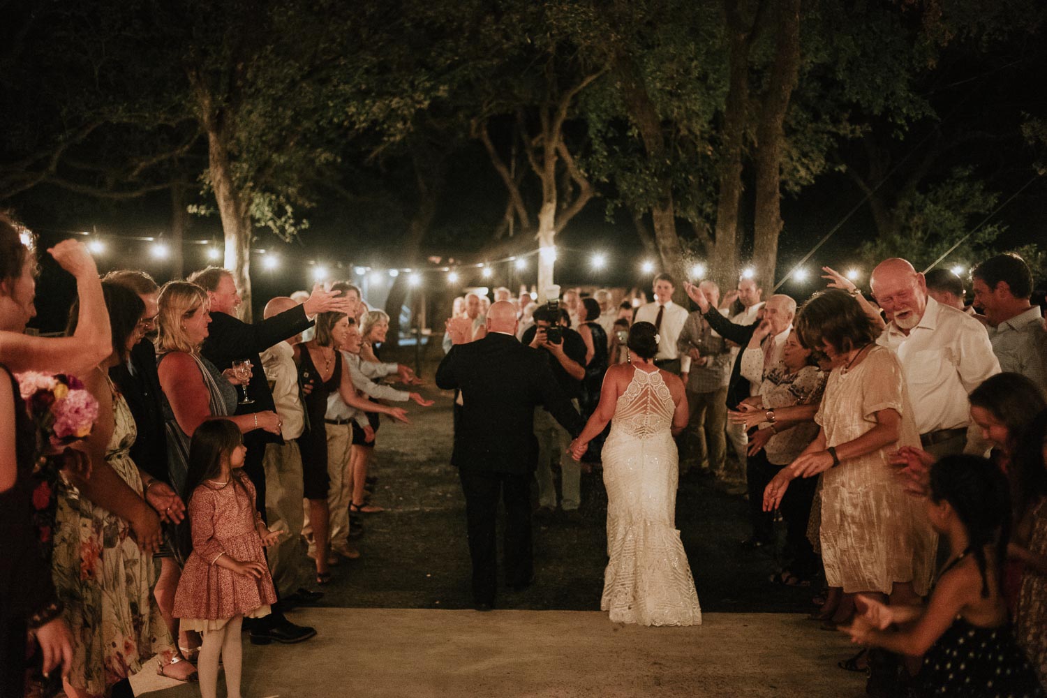 Back shot of couple leaving wedding reception