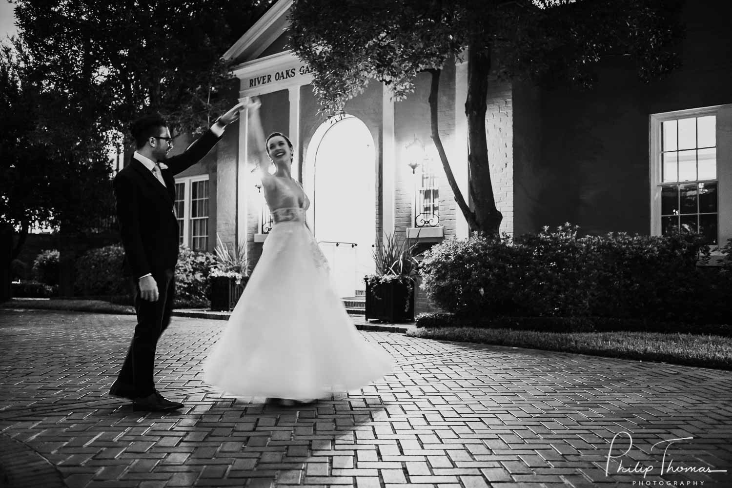 A groom twirls his new bride at River Oaks Garden Club Forum in Houston, Texas.