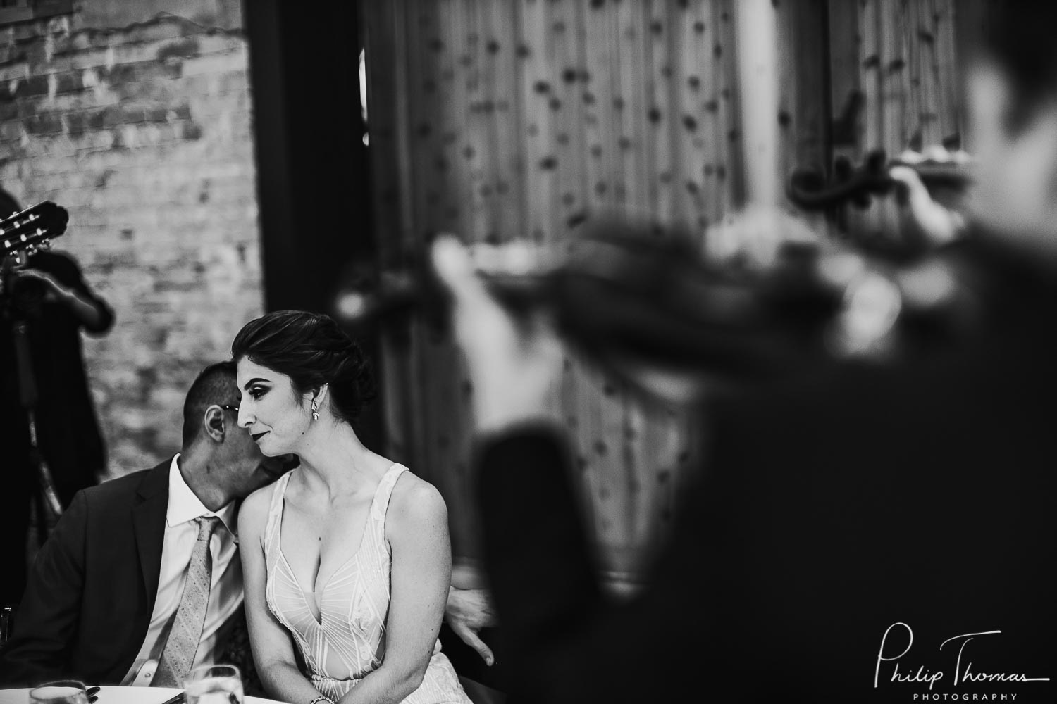Claire and Carlos share a moment as mariachis play in foreground - 37 Philip Thomas Photography-Sunset Station Wedding San Antonio documentary weddings