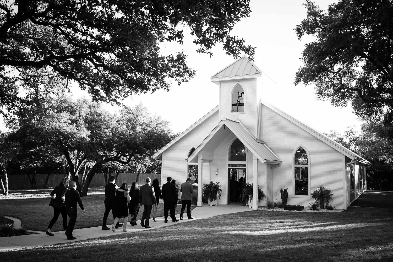 Guests arrive and enter the chapel moments away from the ceremony starting - 09-The Chandelier of Gruene Weding Photos -L1003973-Philip Thomas Photography