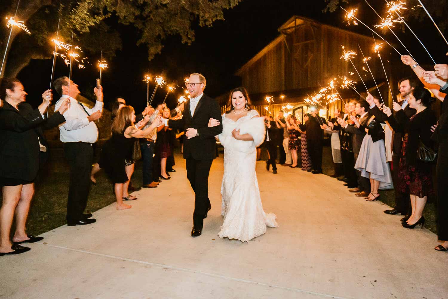 Andrea and James depart the venue under sparklers surrounded by friends and family -The Chandelier of Gruene Weding Photos -HP9A6367-Philip Thomas Photography