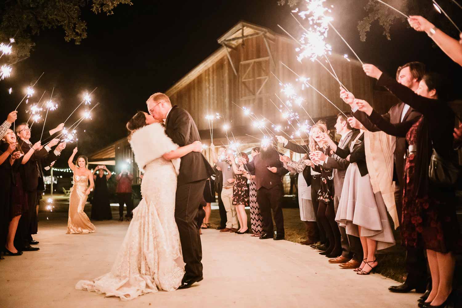 The couple try again for the second time and kiss as they depart the venue- 53-The Chandelier of Gruene Weding Photos -L1004851-Philip Thomas Photography