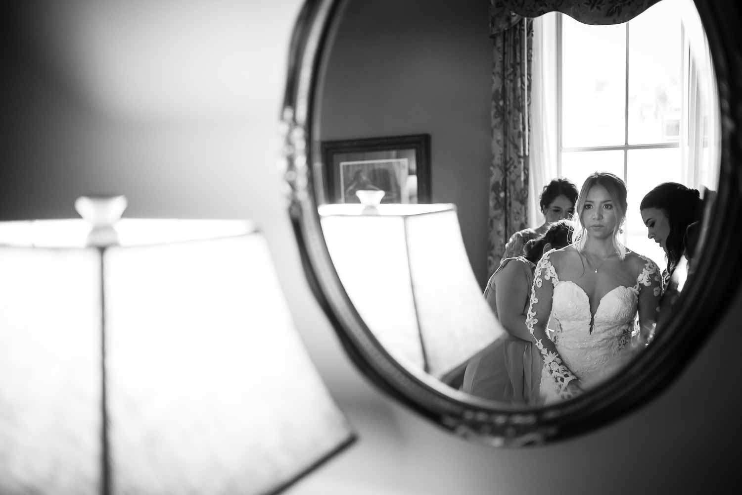 Stephanie the bride checks in the mirror at the Menger Hotel Wedding Ceremony San Antonio Reception Grand BallroomSan Antonio -Leica photographer-Philip Thomas Photography