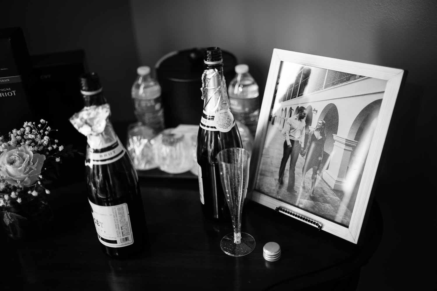 Detail shot of emgagement photo in a frame surrounded by champagne at the Menger Hotel Wedding Ceremony San Antonio Reception Grand BallroomSan Antonio -Leica photographer-Philip Thomas Photography