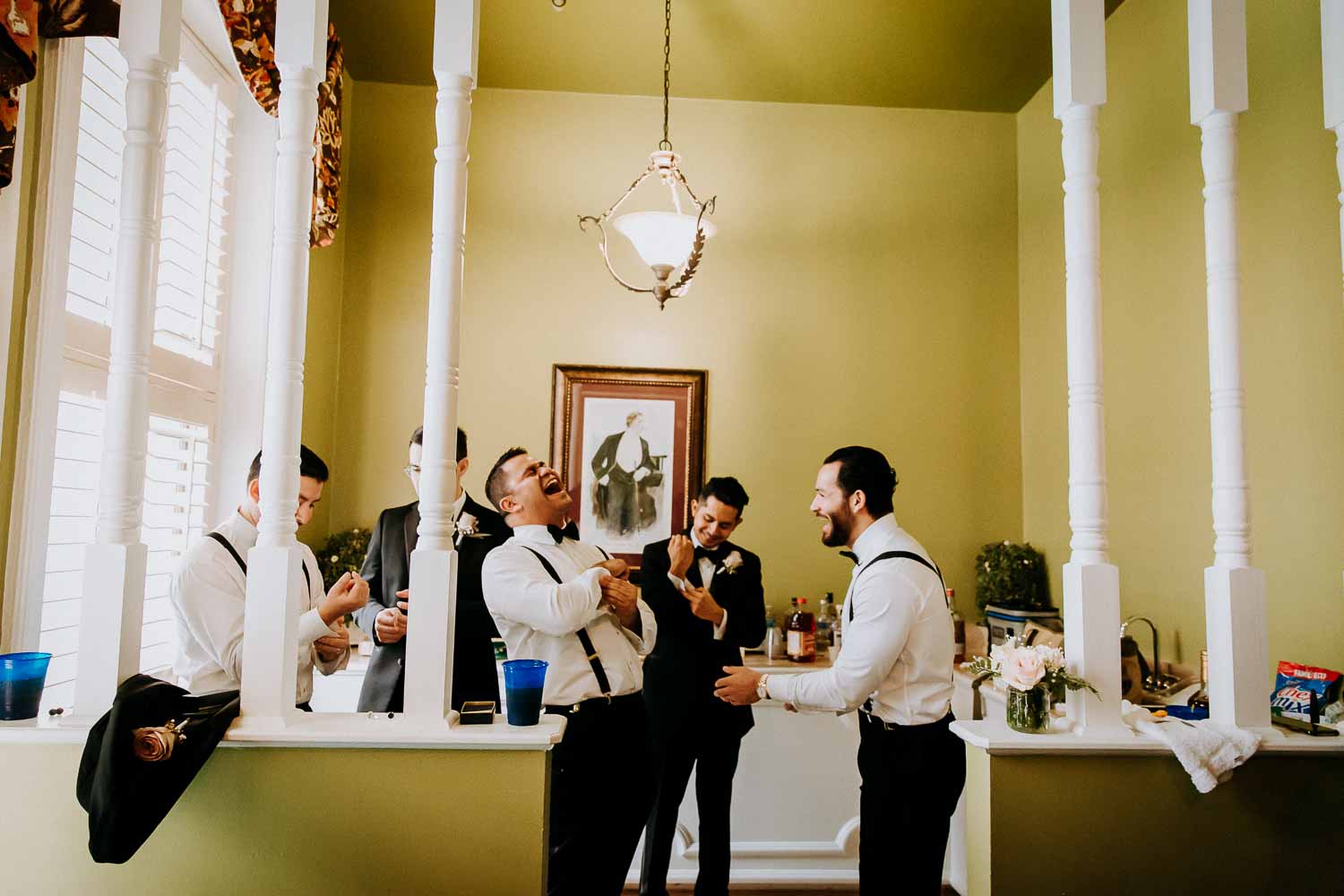 The groom and groomsmen share a joke at the Menger Hotel Wedding Ceremony San Antonio Reception Grand BallroomSan Antonio -Leica photographer-Philip Thomas Photography