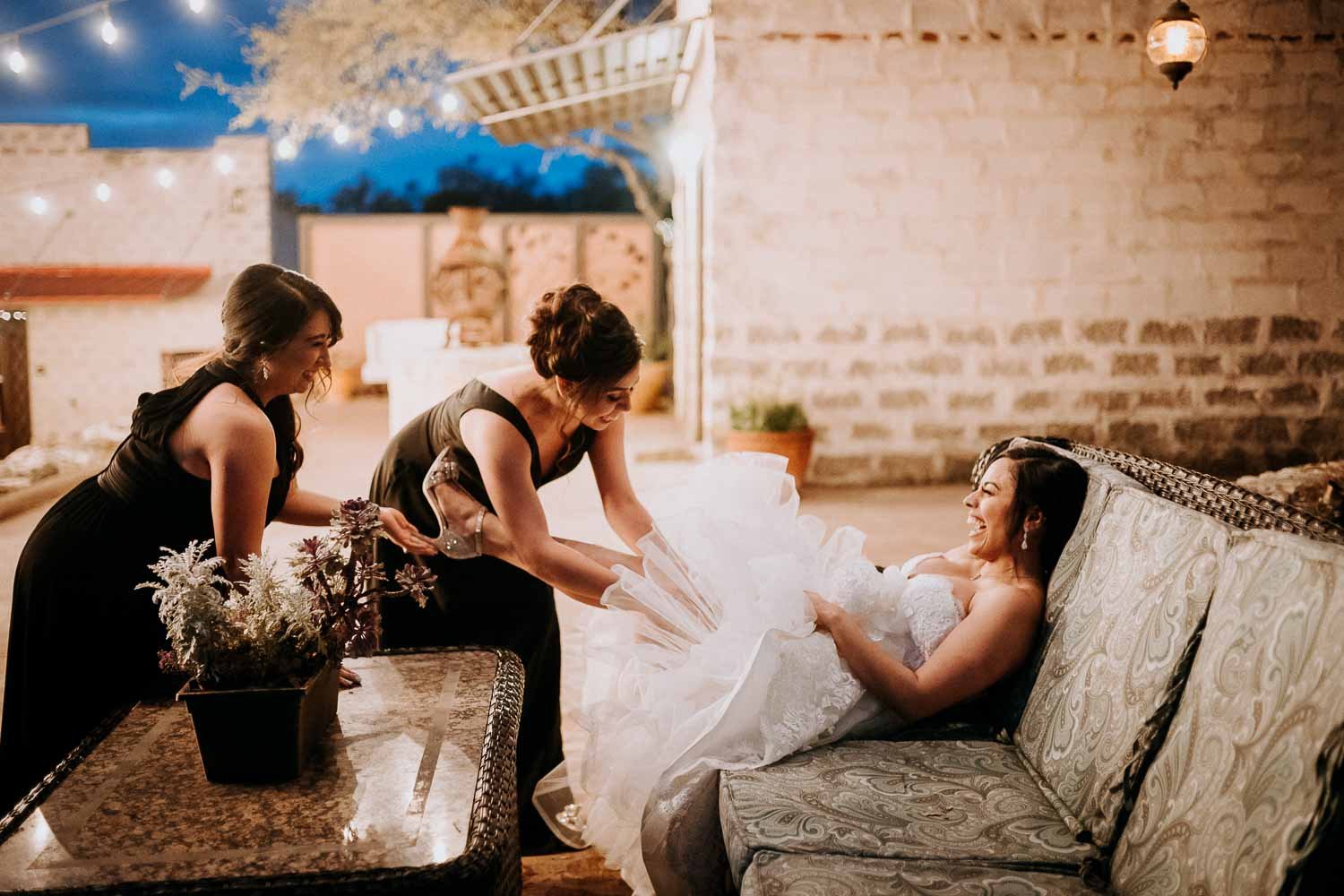 My favorite wedding images of 2019 - Mother and sister help adjust a brides garter in a humorous moment The Oaks at Heavenly Wedding and reception-Leica photographer-Philip Thomas Photography