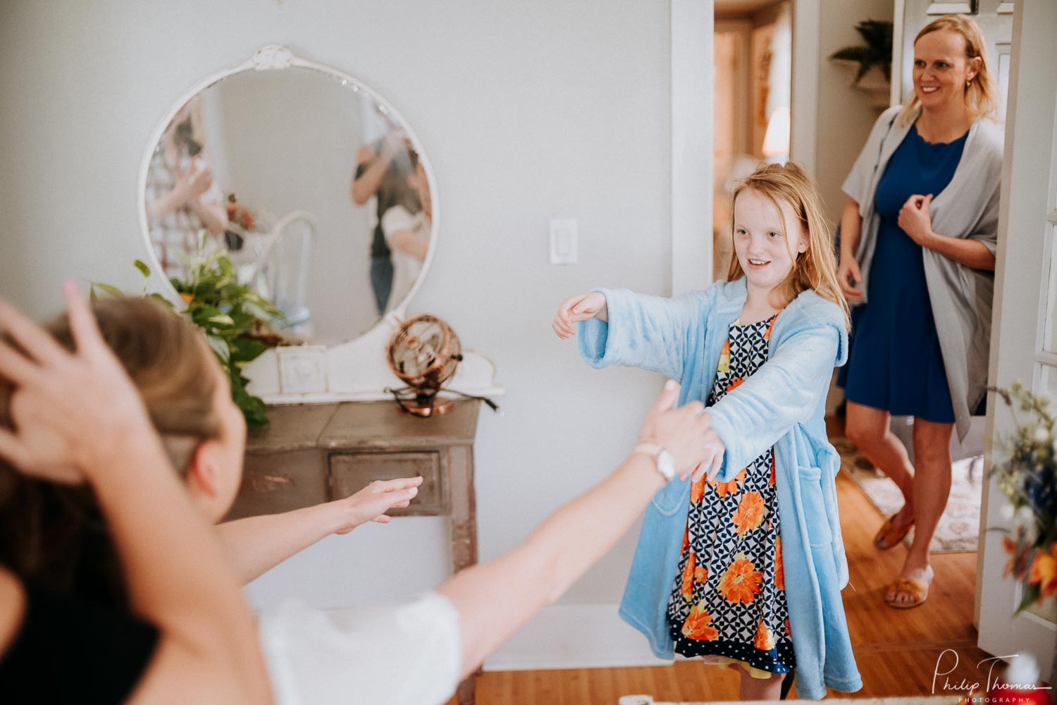 A flower-girl greets the bride on her wedding day at The Grand Texana Wedding Barn