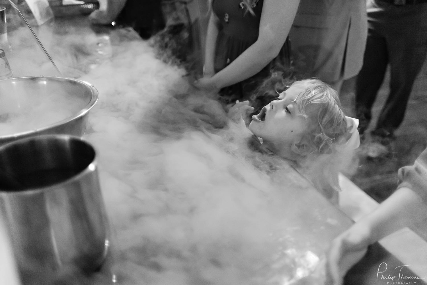 My favorite wedding images of 2019 shows a small girl playing with smoked ice at a dessert station