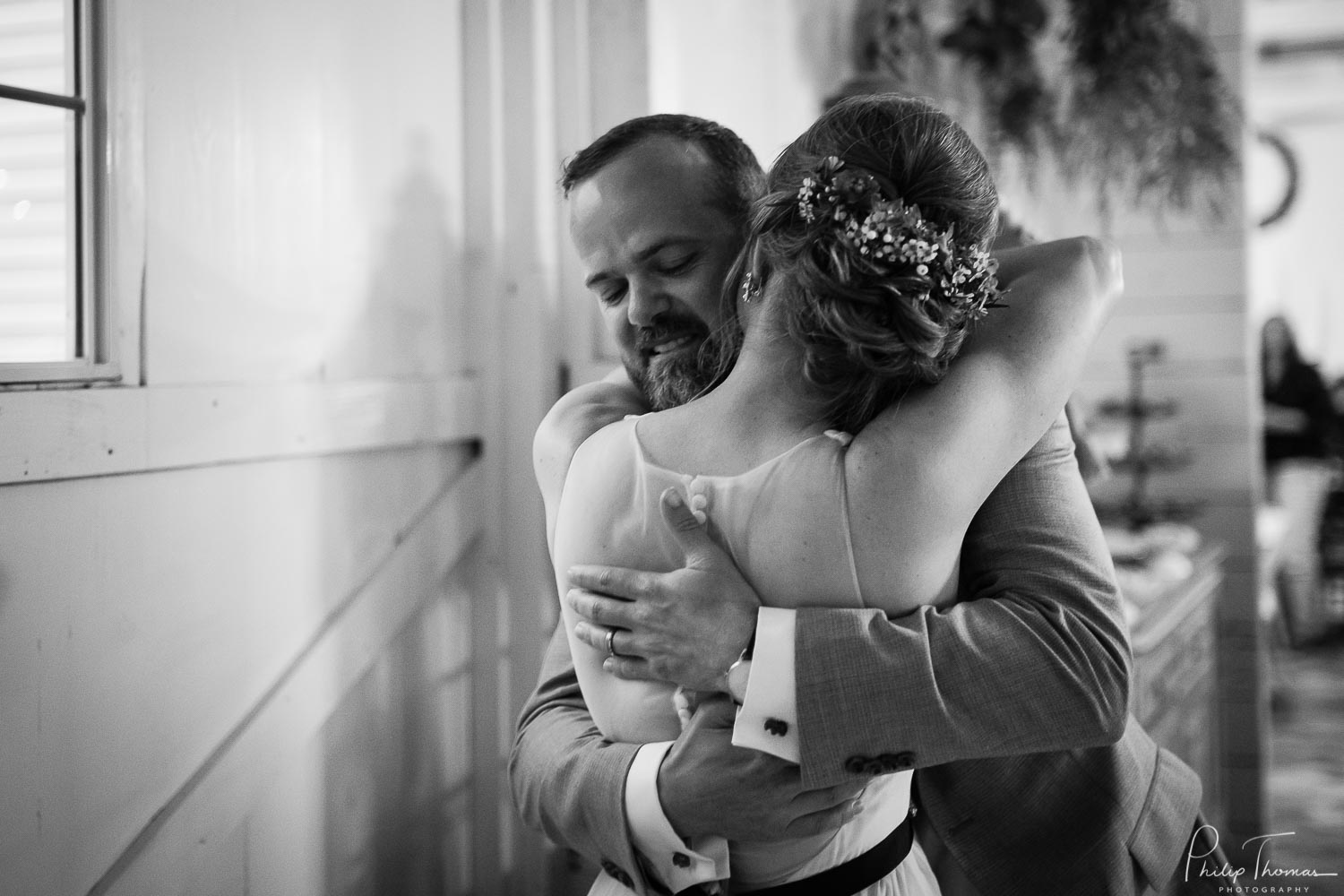 Couple hug after cutting the cake at The Grand Texana Wedding Barr Minta + Phillip -