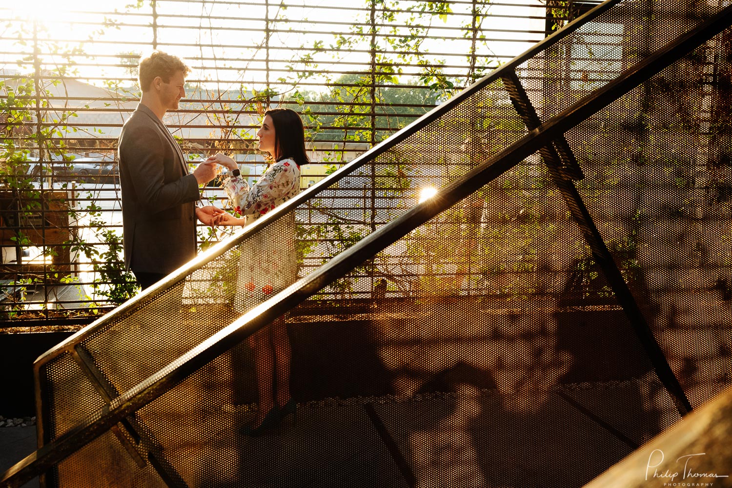 Approaching sunset, couple hold hands as shadow falls on staircase leading to the pool -South Congress Hotel-Leica photographer-Philip Thomas Photography