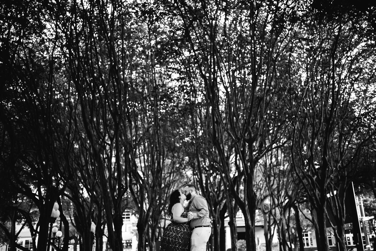 In and around the beautiful tall trees out front of Wortham Theater Center Luci and Bryans engagement session downtown Theater District Houston Texas-Philip Thomas Photography