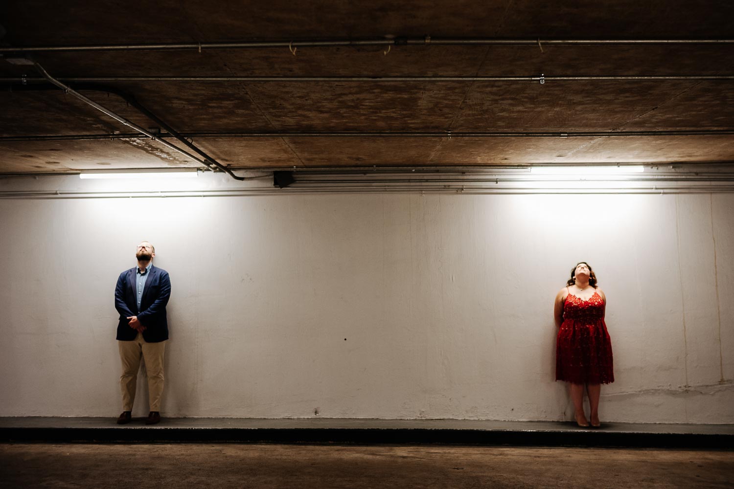 Along a wall exit Alley Theatre Center Garage Luci and Bryans engagement session downtown Theater District Houston Texas-Philip Thomas Photography