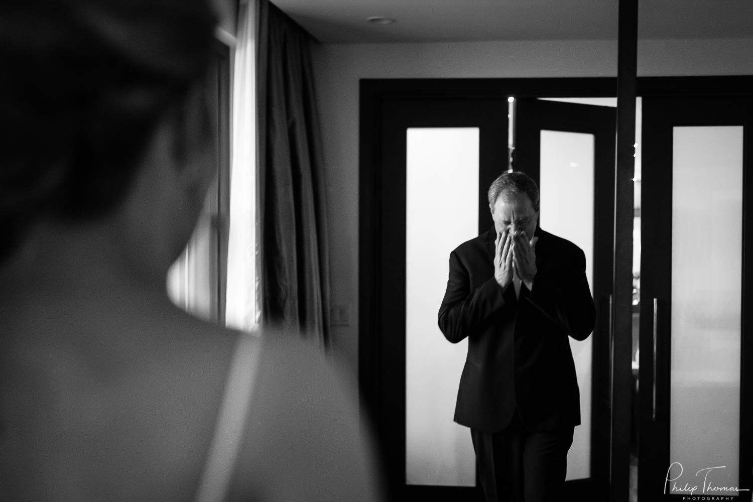 Father of the bride reacts with emotion seeing his daughter in her wedding dress - The JW Marriott Downtown Houston bride and groom get ready -Philip Thomas Photography