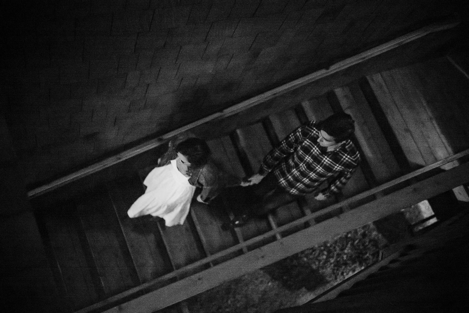 Couple at Banger's in Austin walk down staircase looking down
