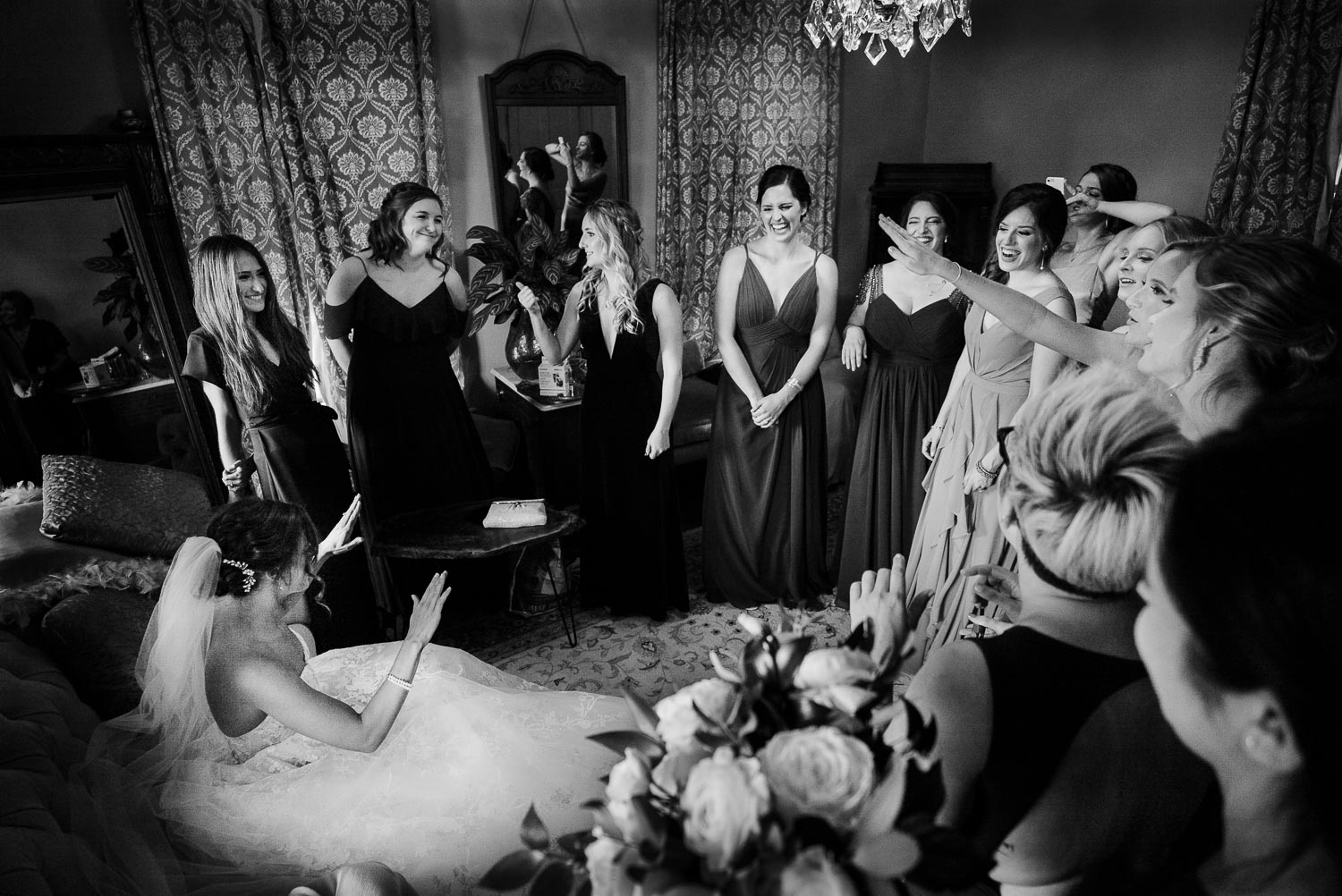 Bridesmaids surround the bride and breakout in a favorite song inside the main cottage Barr Mansion, Texas