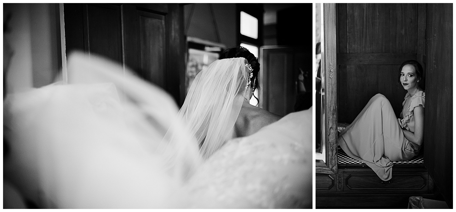 View from behind bride as she walks through a door frame at Barr Mansion, Texas. On the right, a bridesmaid finds a cozy spot in a closet