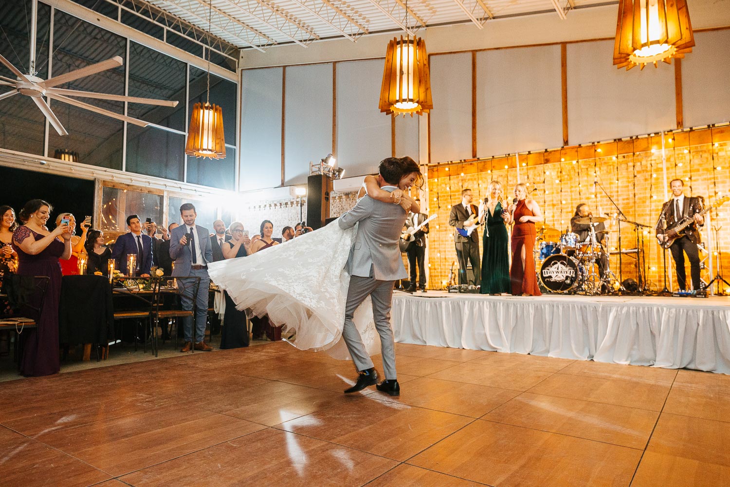 First dance groom sweeps bride of her feet as they twirl at Barr Mansion, Texas