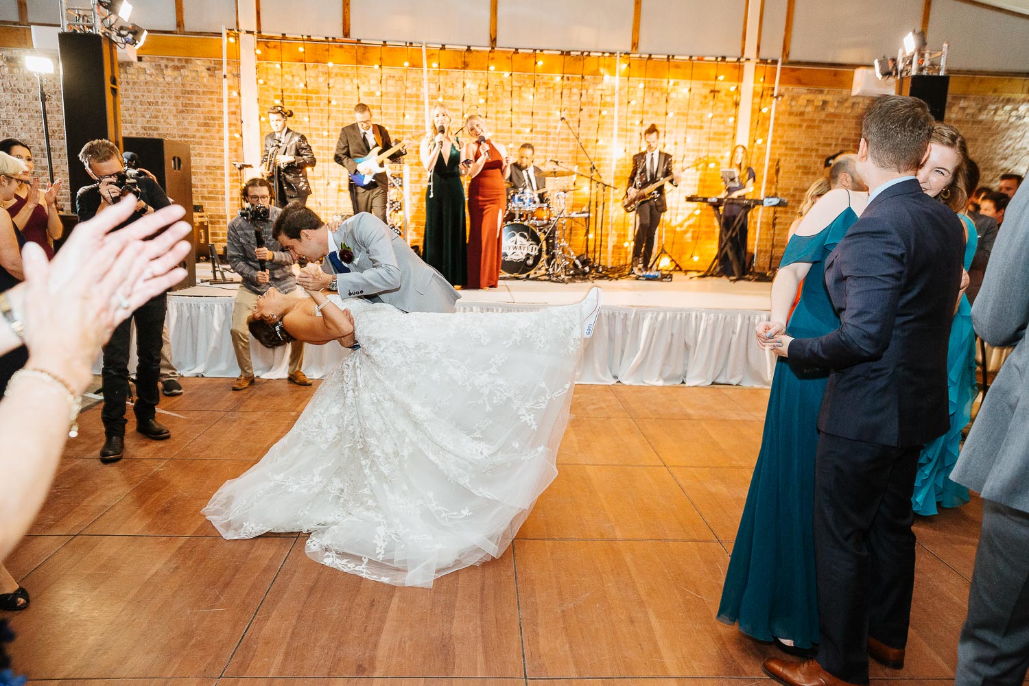 Groom dips bride at culmination of wedding reception at Barr Mansion, Texas