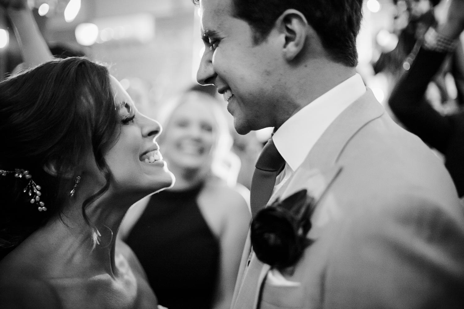 Couple surrounded by family and friends on dancefloor in the farmstead building at Barr Mansion, Texas