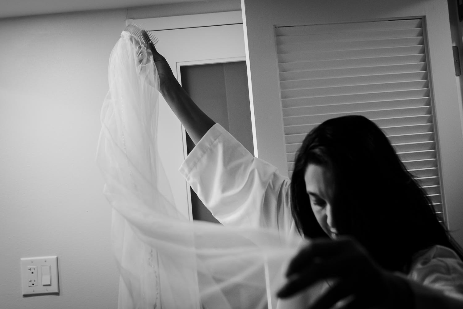Bride lifts her veil at Omni La Mansion Riverwalk hotel in San Antonio Texas
