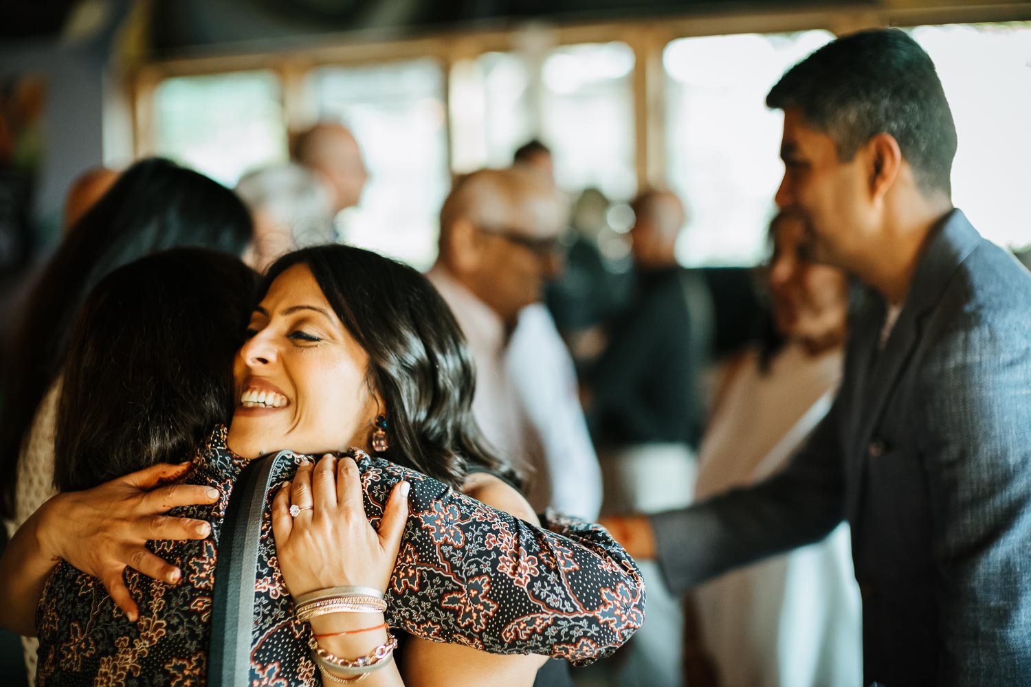 During a rehearsal dinner the bride hugs a guest at The Infinite Monkey Theorem