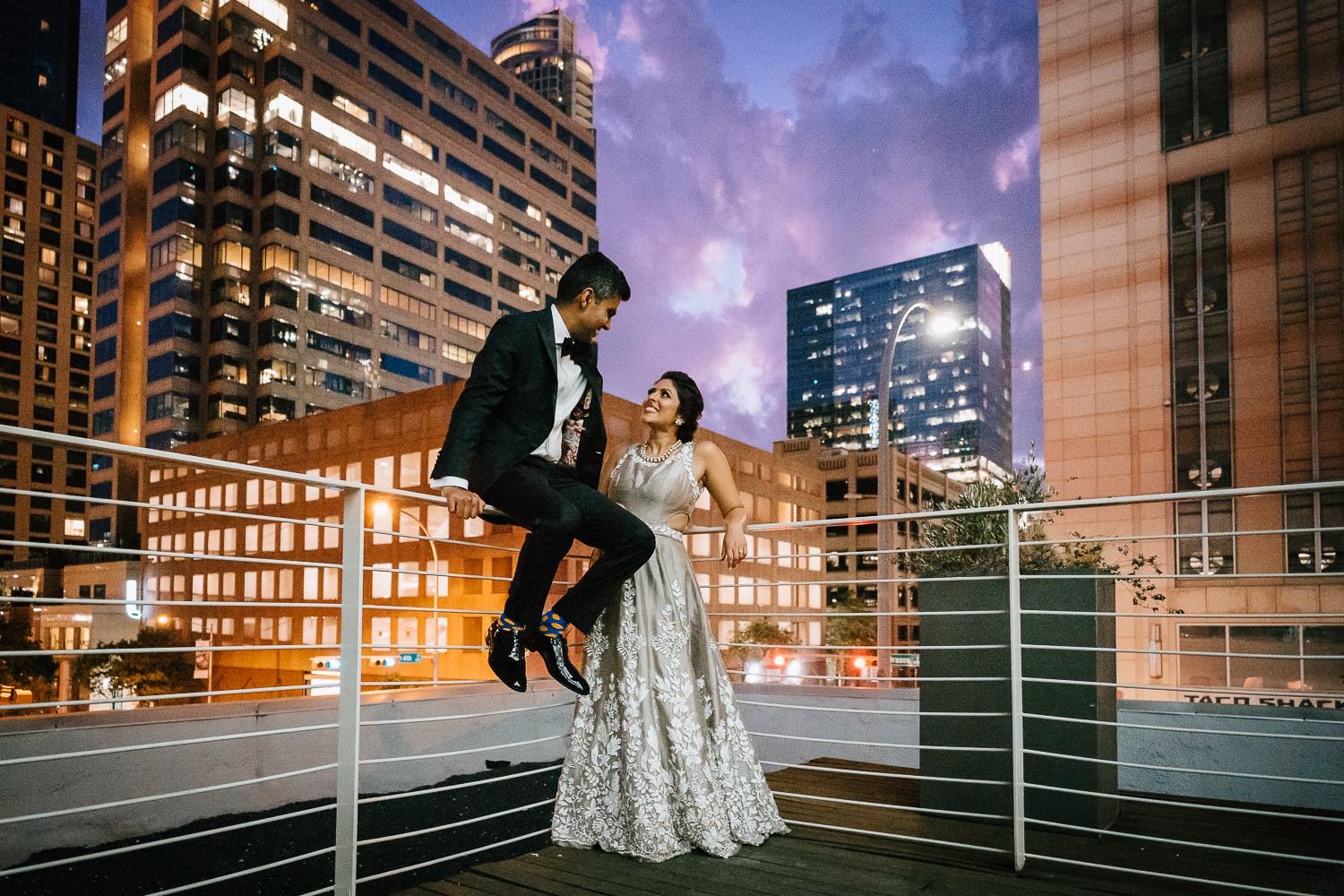 Newlywed couple Neha and Mrugesg pose on top of Brazos Hall with night time view of downtown Austin Brazos-Hall-South-Asian-Indian-wedding-_-Neha-Mrugesh-Philip-Thomas-Photography-1