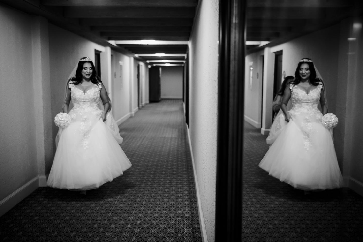 Walking down the corridors of Omni La Mansion Riverwalk hotel in San Antonio Texas the bride is reflected in a mirror