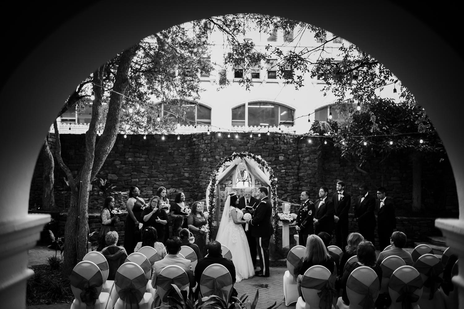 A monochrome image wide view at Omni La Mansion Riverwalk hotel in San Antonio Texas wedding ceremony