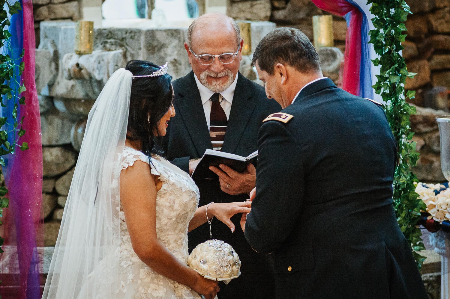 Walt the groom slips on a wedding ring to Blanca the bride