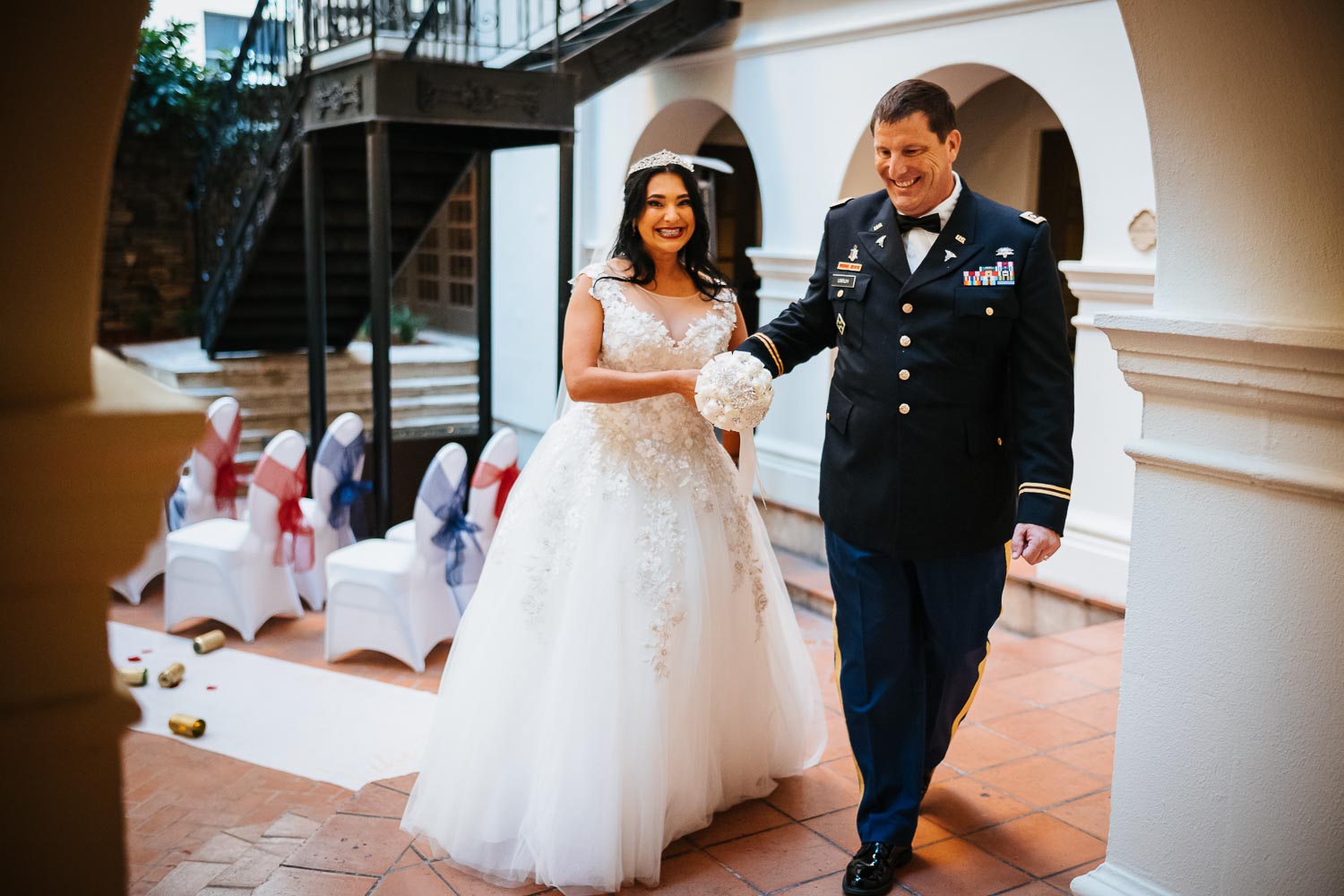 The newly minted wedding couple slip away from the courtyard at Omni La Mansion Riverwalk hotel in San Antonio Texas