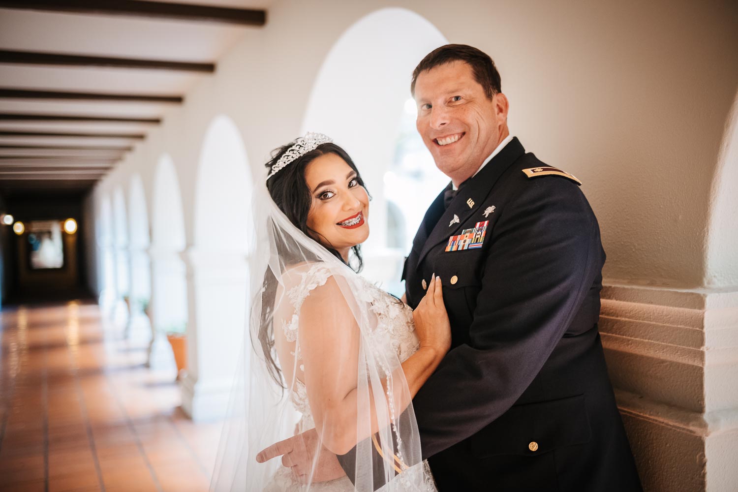 The couple pose for a just married picture at Omni La Mansion Riverwalk hotel in San Antonio Texas