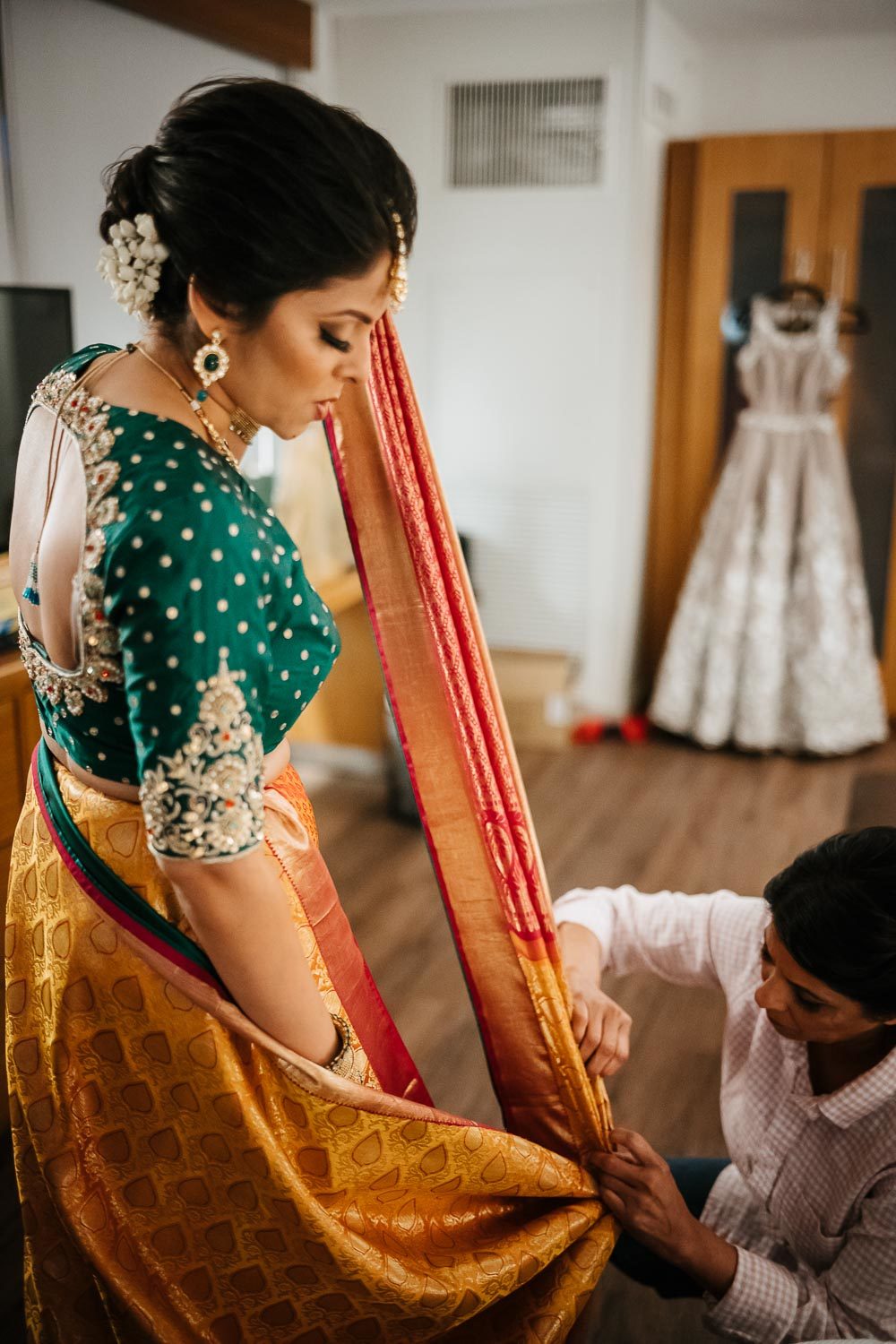 Bride starts to dress in her sari at at Hyatt Place Austin for her wedding
