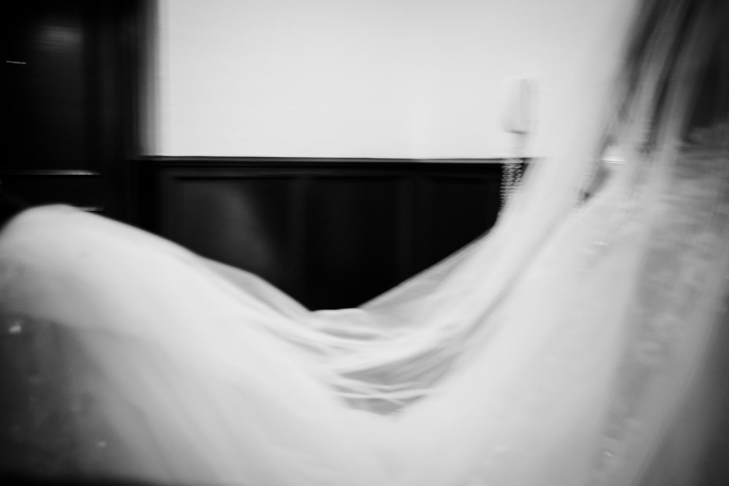 The brides dress in a slow speed shutter image at Omni La Mansion Riverwalk hotel in San Antonio Texas on her wedding day