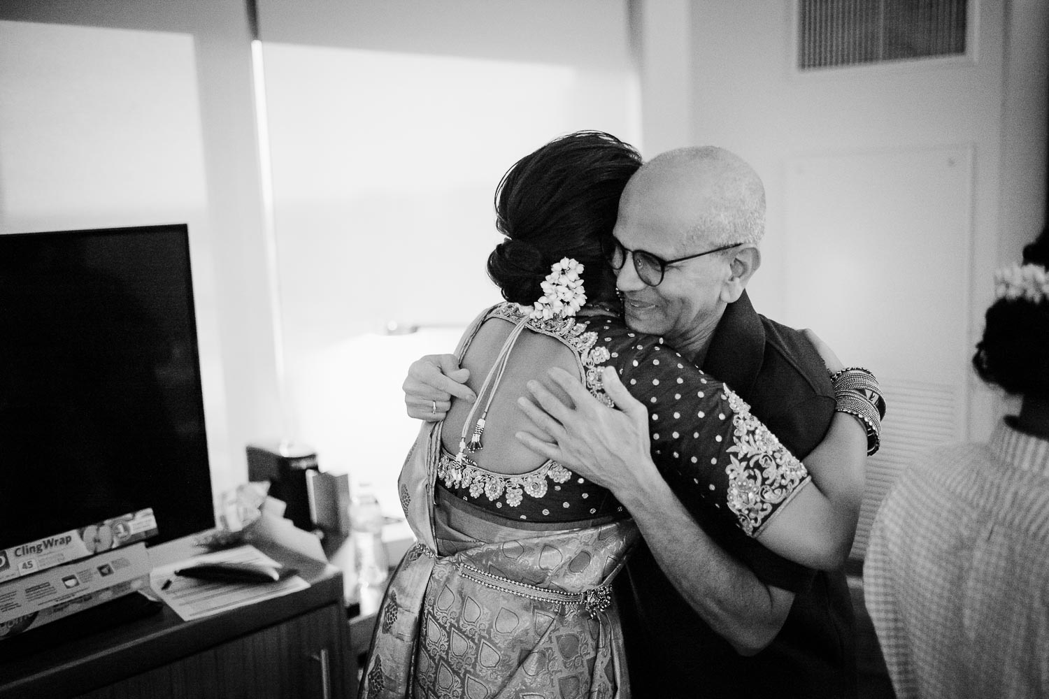 Father of the bride and daughter hug when he sees her in her sari for the first time at Hyatt Place Austin