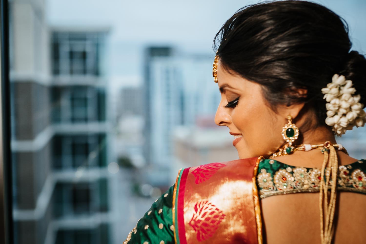 Indian bride looks to her left with the Austin skyline in background