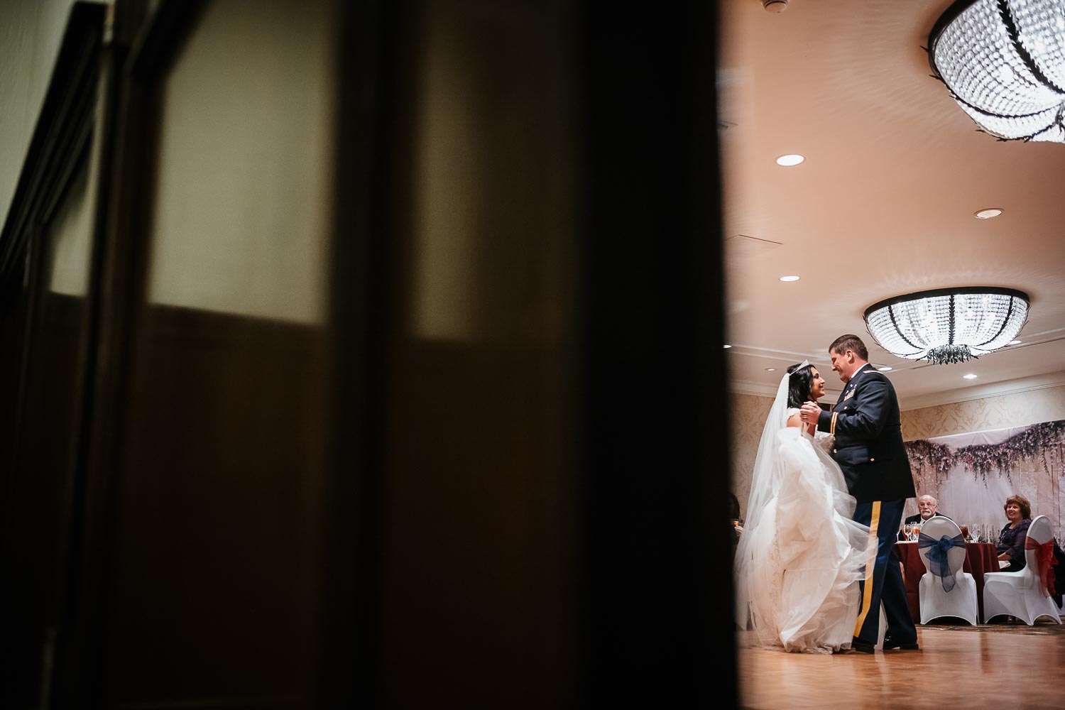 The couples first dance photographed through the reception doors