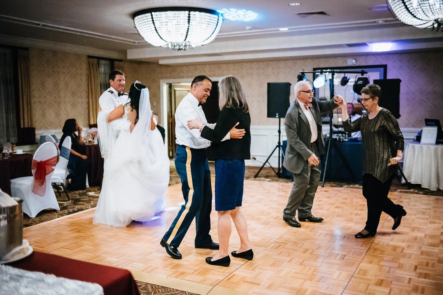Friends and family dance the night away in an intimate wedding reception at Omni La Mansion Riverwalk hotel in San Antonio Texas