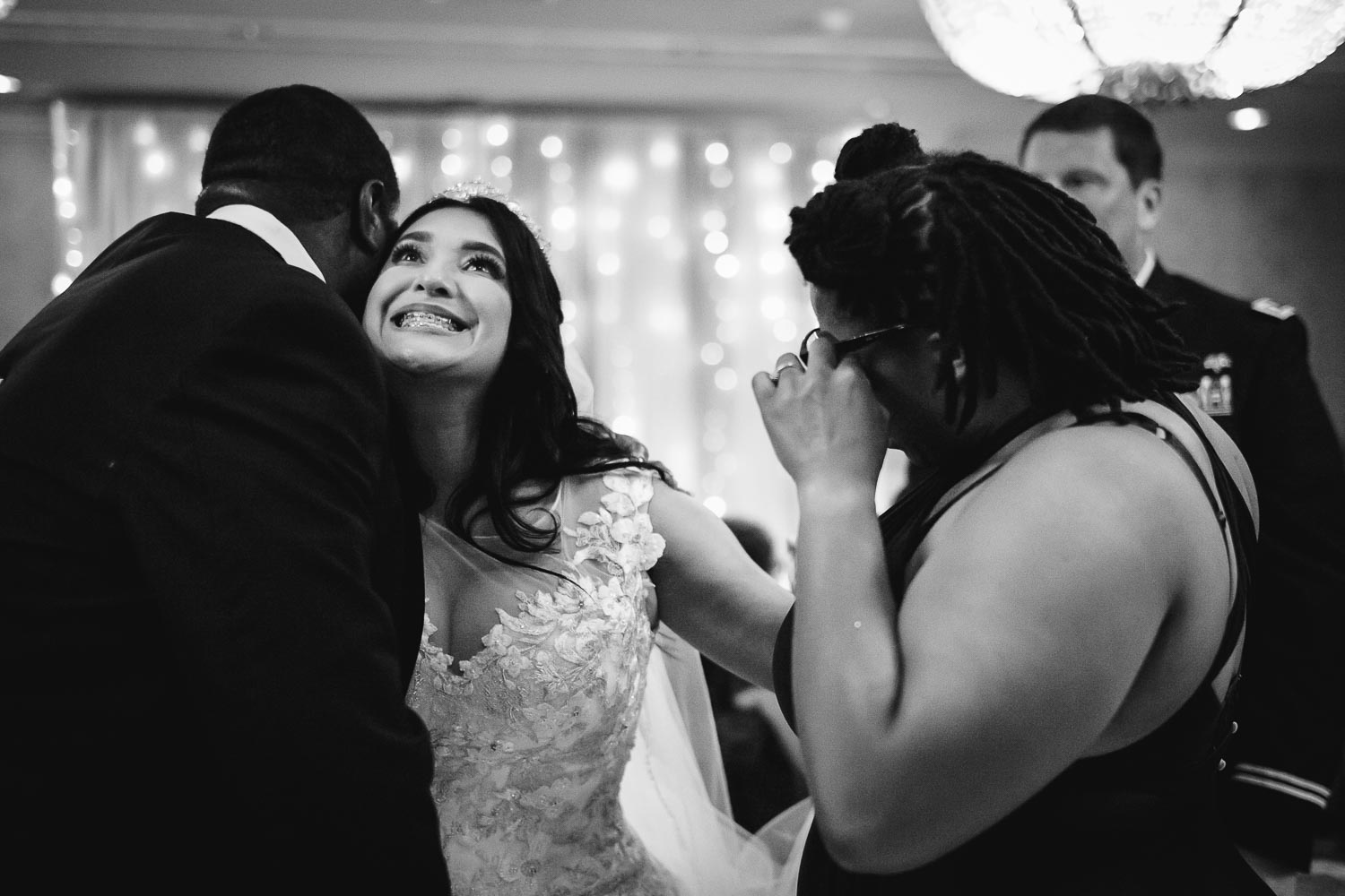 Bride hugs friends and guest wipes tears way at Omni La Mansion Riverwalk hotel in San Antonio Texas shot with a Leica M10-P