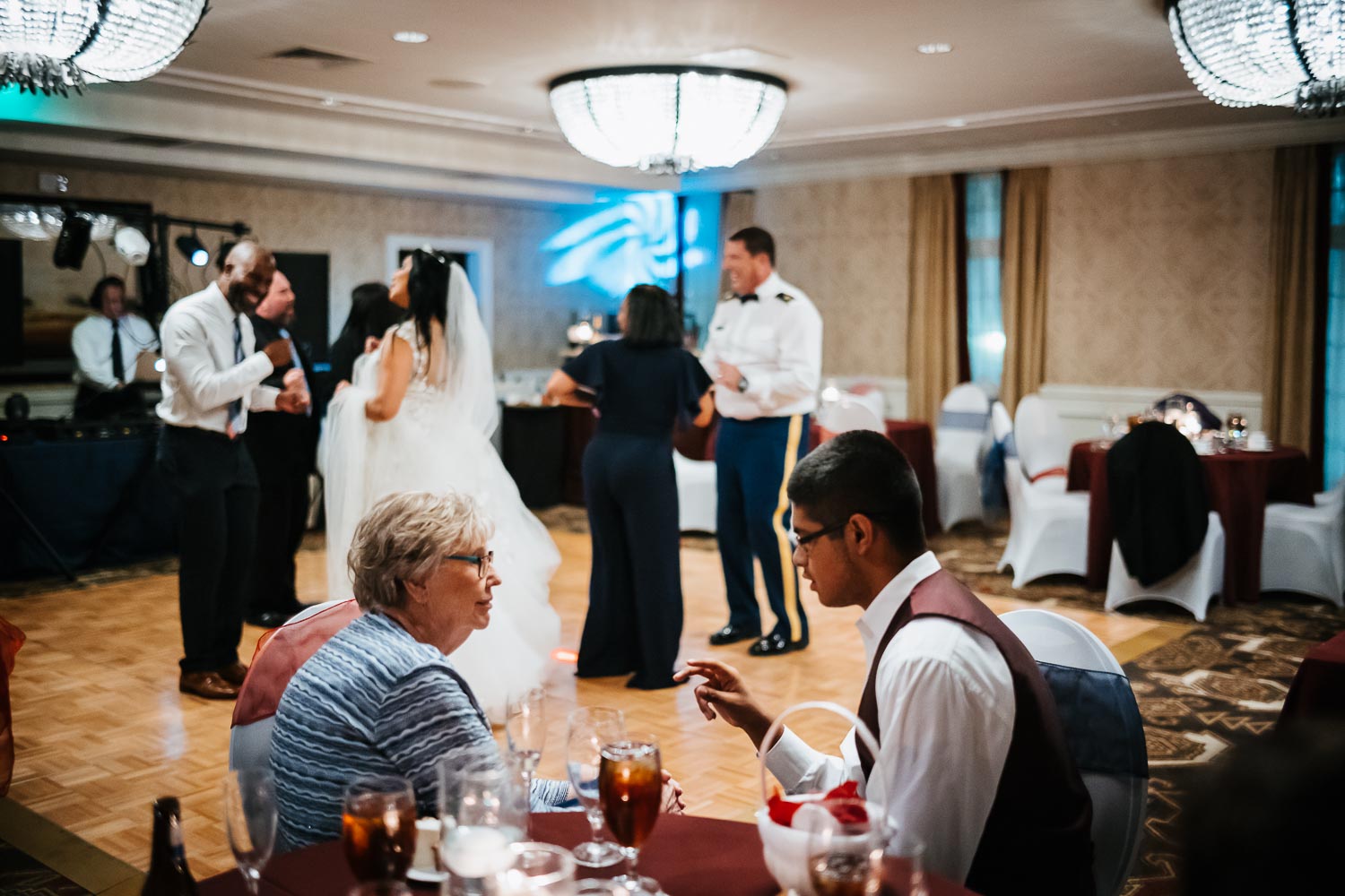 Bride, groom and family dancing on reception floor