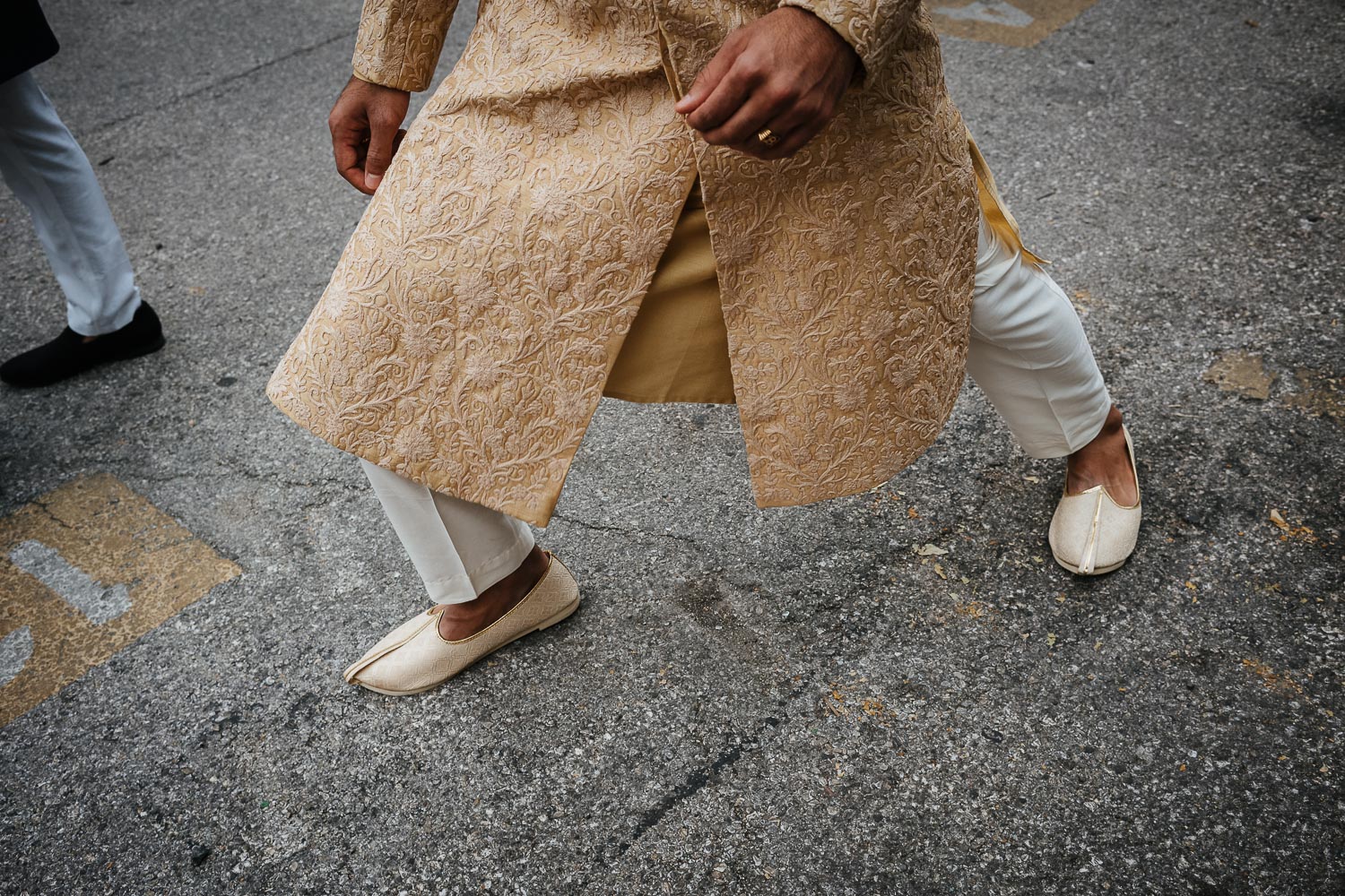 During the moments before the baraat the groom playfully moves his feet Brazos Hall Austin South Hindu asian wedding ceremony