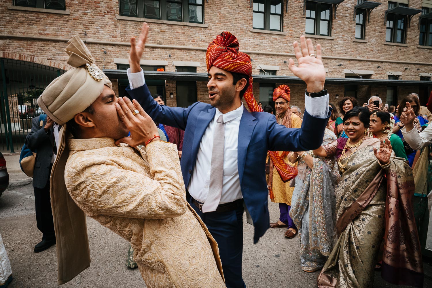Baraat festivities with the groom and guests in blue suit