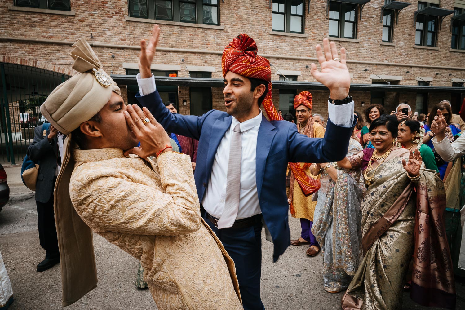 Baraat festivities with the groom and guests in blue suit