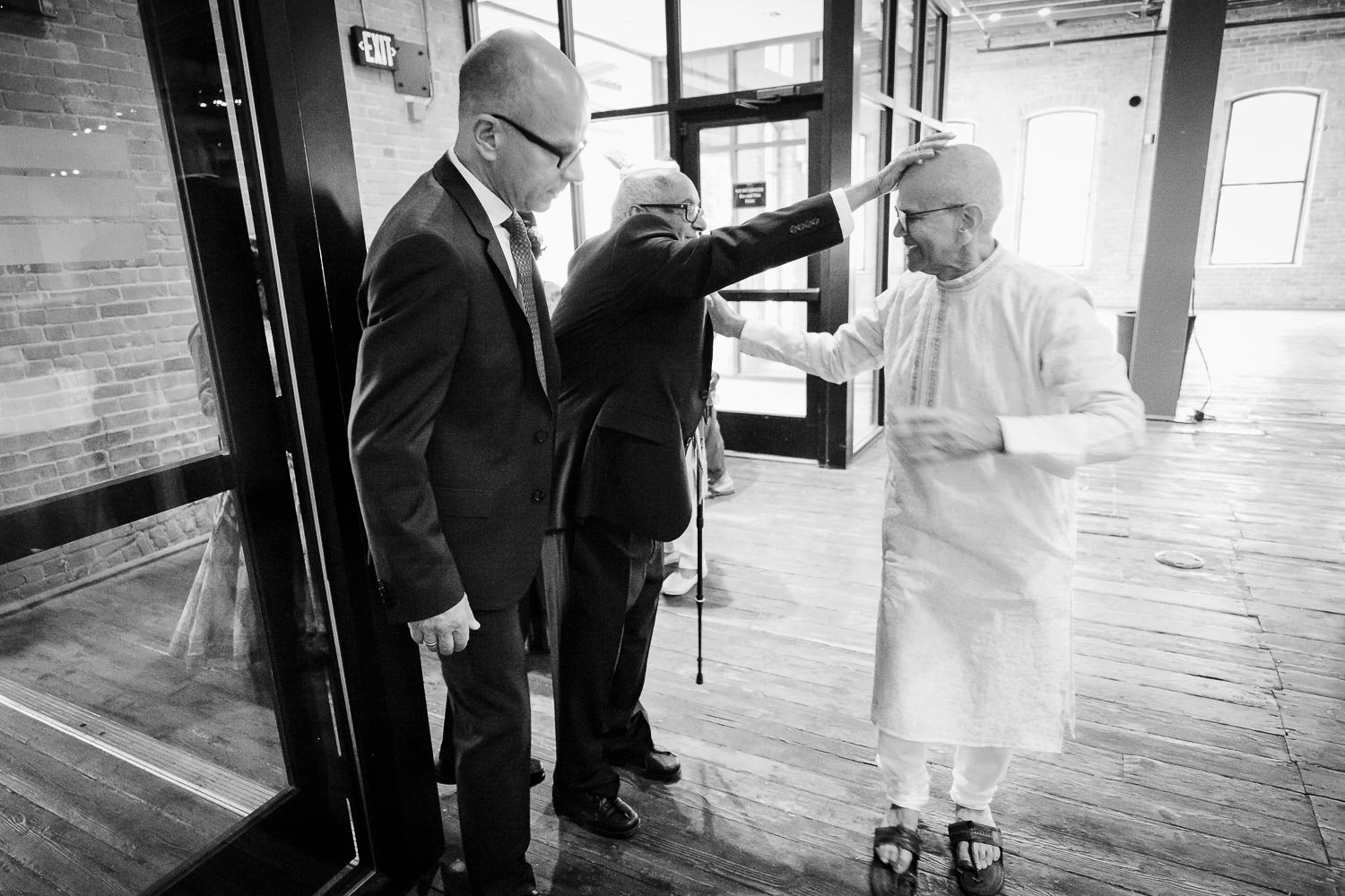 A humorous moment as a friend of the father of the bride pats his head