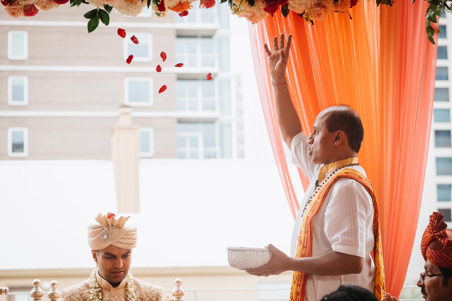 During the Hindi Ceremony the priest throws petals into the air Brazos Hall Austin South Hindu asian wedding ceremony